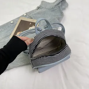 Mini vintage blue striped backpack with dual zippers and woven texture details