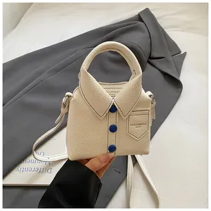 Macro view of shirt-style off-white bag featuring blue buttons and textured leather finish