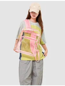Detail of pink transparent PVC backpack with durable stitching and front zipper pocket