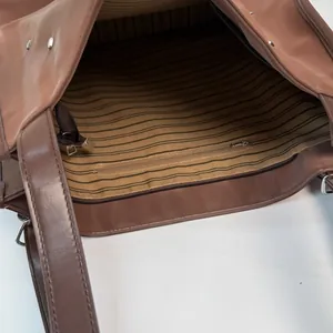 Brown faux leather tote bag interior with striped lining and large capacity compartment