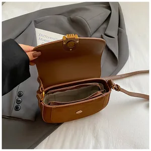 Vintage brown leather crossbody bag with flap and internal zip compartment