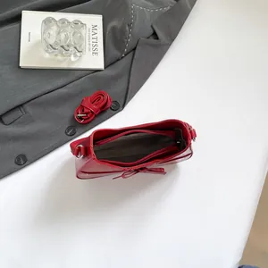 Red bow baguette shoulder bag for women with polished finish and adjustable strap
