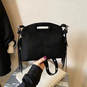 Minimalist black suede handbag with fringe tassels and metal eyelet strap for women
