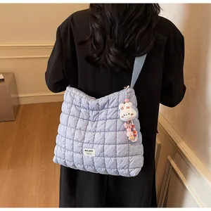 Detailed shot of light blue quilted cloud bag with cute rabbit pendant and Mulaidi logo
