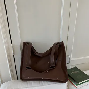 Minimalist large brown tote bag with silver metal rivets for women's daily commute
