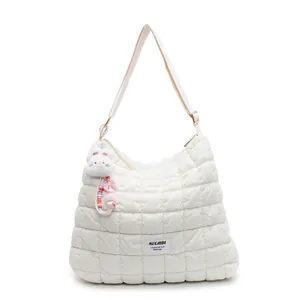 White quilted puffer crossbody bag with cute bunny pendant and adjustable strap