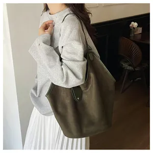 Sac cabas en daim vert foncé avec vue de profil sur mannequin pour mode urbaine