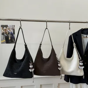 Three minimalist large-capacity tote bags in black, brown and beige with dog charms