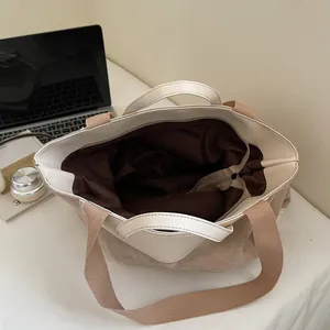 Minimalist beige corduroy tote bag with leather trim and brown fabric lining