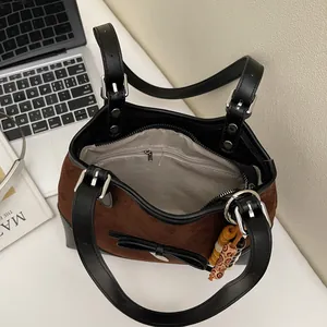 Chic autumn leopard print tote bag with brown suede and black leather straps in an office setting