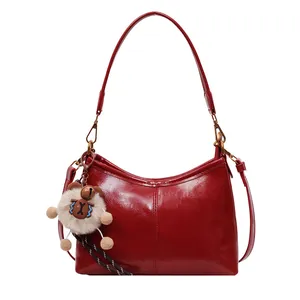 Glossy red faux leather tote bag with moon shape and cute plush bear charm
