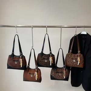 Collection of retro leopard print tote bags with heart charms and decorative tassels