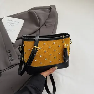 Yellow and black frosted bucket bag with diamond stitching and rhinestone details