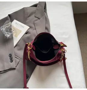Top view of burgundy matte handbag showing interior lining, slip pocket, and gold zipper
