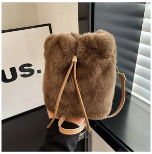Detail of plush brown bucket bag showing soft faux fur texture and drawstring metal slider