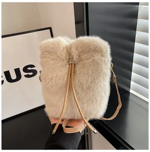 Detail of plush beige bucket bag featuring soft faux fur texture and drawstring closure