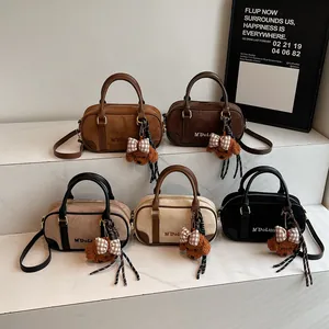 Minimalist bowling bag with teddy charm in five colors including dark brown and beige