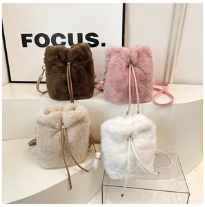 Close-up of plush bucket bags with drawstring closure in four autumn colors