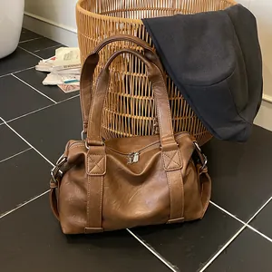 Vintage brown leather tote bag with a minimalist large capacity pillow design for travel