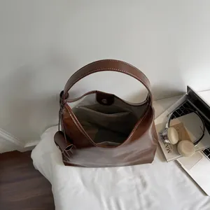 Modern coffee brown leather tote bag with wide strap and spacious interior for work