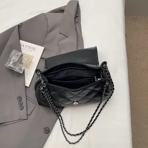 Quilted black leather tote bag with chain strap and multiple interior compartments