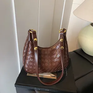 Dark brown woven leather hobo shoulder bag with crescent shape and gold hardware