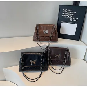 Three elegant quilted tote bags with butterfly buckles in black, brown, and coffee colors