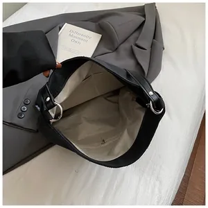Minimalist black canvas bucket bag with spacious interior and functional pockets