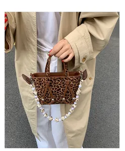 Detail of leopard print tote bag featuring stylish beaded strap and canvas texture