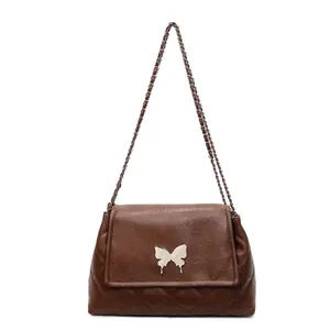 Brown quilted leather tote bag with butterfly buckle and metal chain strap for women