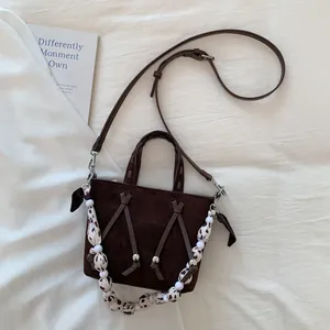 Top view of retro brown suede tote bag with leopard print handle and beaded details