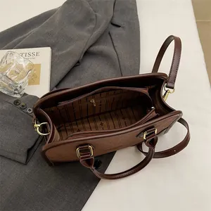 Retro dark brown leather crossbody bag with star pattern lining and golden hardware