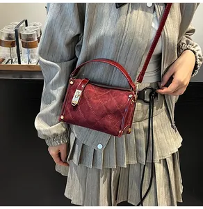 Burgundy square bag in quilted leather shown on model for a premium lifestyle look
