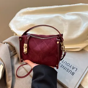 Chic burgundy crossbody bag with diamond quilting and metallic hardware closure