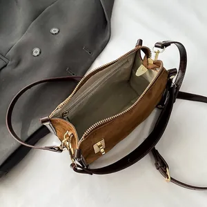 Brown faux suede square shoulder bag with adjustable strap and golden hardware accents