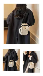 Detail of waterproof oxford shoulder bag featuring dual zippers and adjustable straps