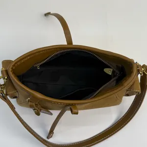 Brown suede leather shoulder bag top view showing interior lining and zipper pocket
