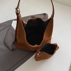 Brown faux suede tote bag with small pouch set on grey blazer, stylish vintage handbag