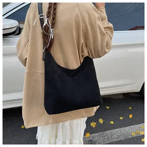 Macro detail of black vintage matte hobo bag with wide leather shoulder strap