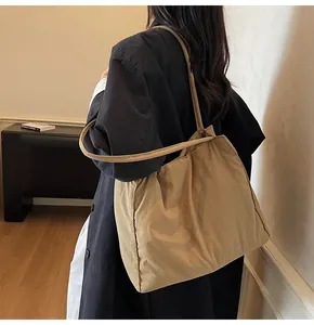 Detailed view of the large khaki minimalist tote bag showing soft nylon material and straps