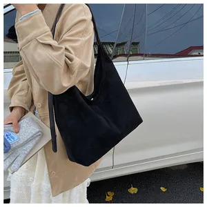 Outdoor view of a black matte leather tote bag featuring a minimalist commute design