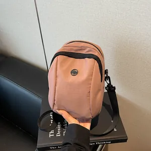 Waterproof contrast nylon crossbody bag in dusty rose pink with adjustable strap