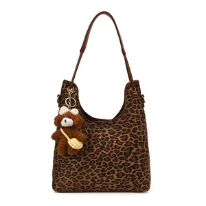 Chic leopard print hobo shoulder bag with brown leather strap and plush bear charm