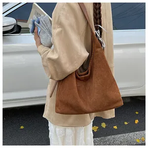 Retro brown matte tote bag shown in an outdoor autumn setting with trench coat style