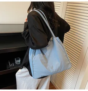 Macro shot of light blue canvas tote bag showing draped texture and spacious interior design