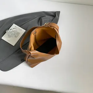 Minimalist caramel brown leather tote bag with magnetic closure and spacious interior