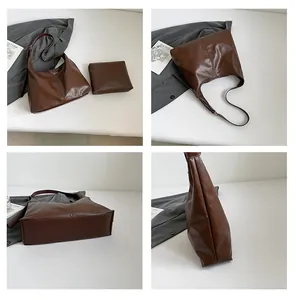Detail view of deep brown oily leather hobo bag and matching zippered storage pouch