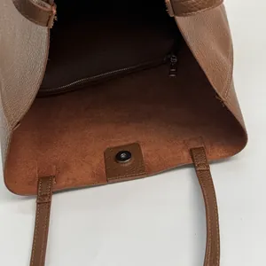 Deep brown lychee grain leather bucket bag with magnetic closure and inner zipper pocket