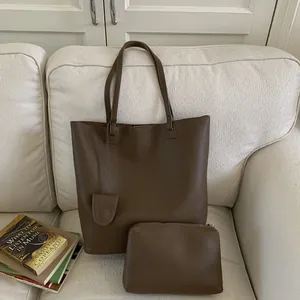 Detail of dark brown pebble leather bucket bag set with matching zippered inner pouch