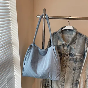 Minimalist misty blue large capacity nylon tote bag hanging with natural light shadows